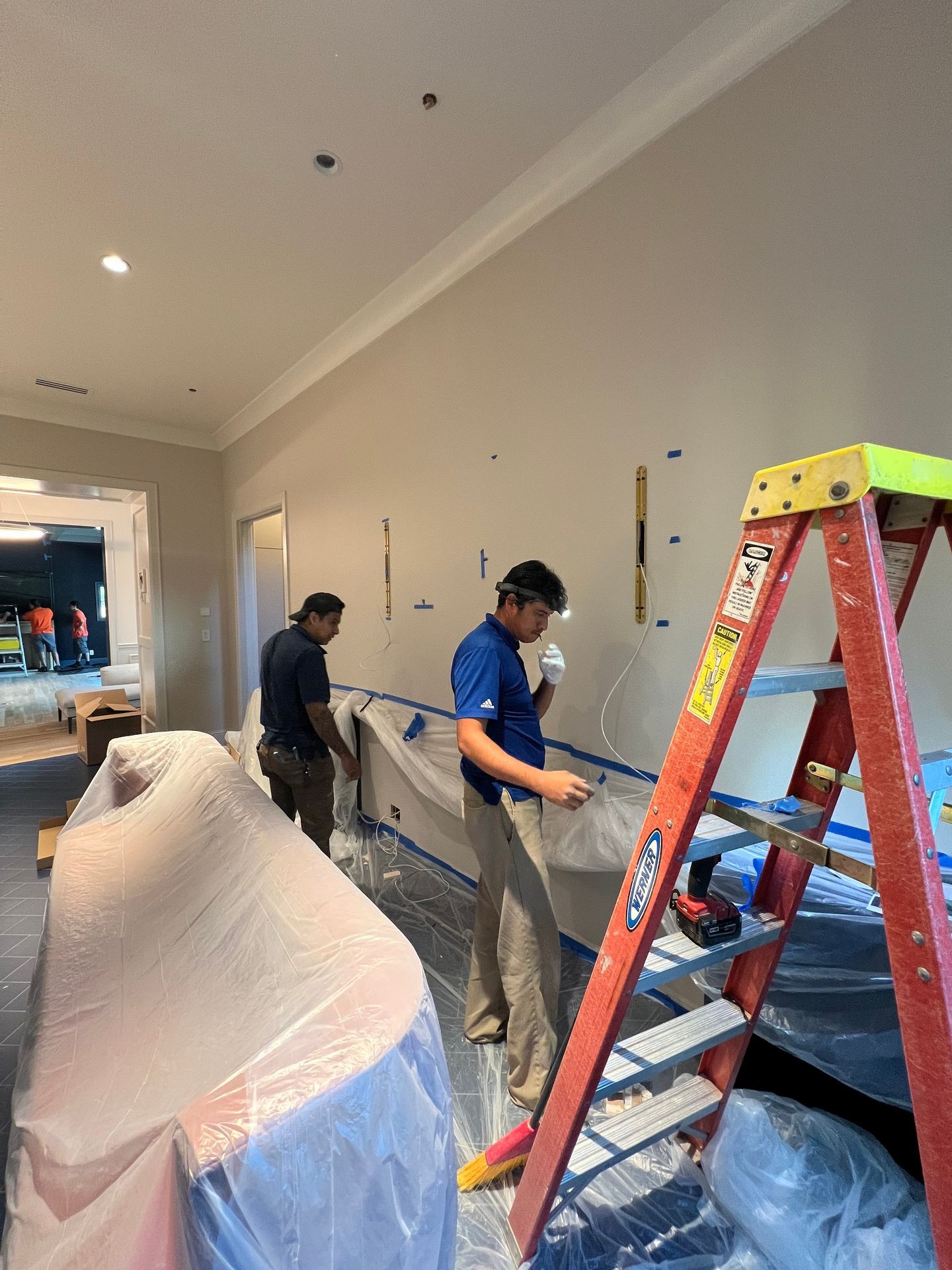 Electrician Installing Wall Light Fixtures