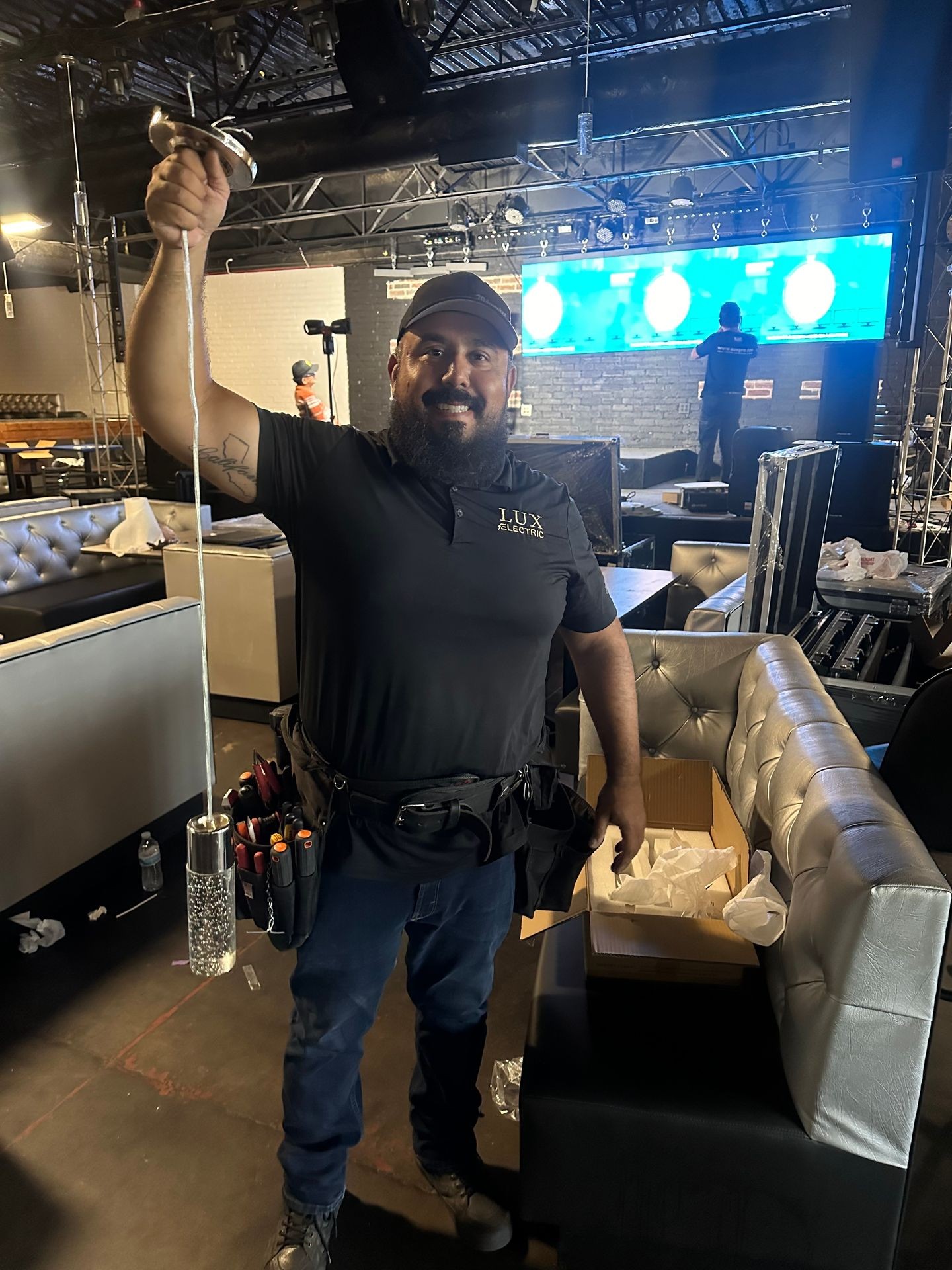 Electrician Holding Light Fixture