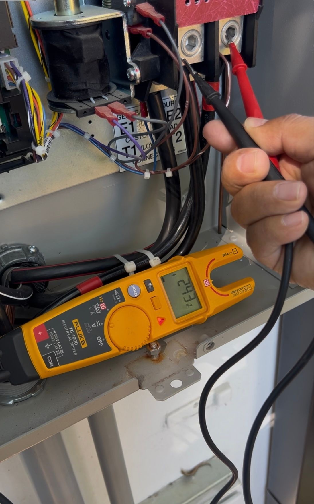 electrician troubleshooting with multimeter