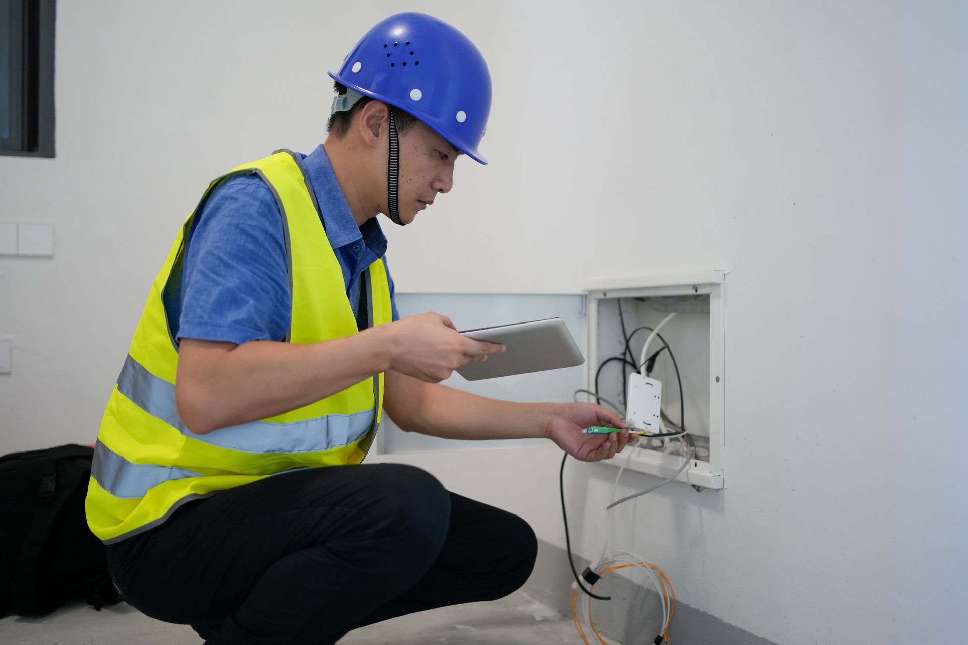 The engineer is checking the wiring