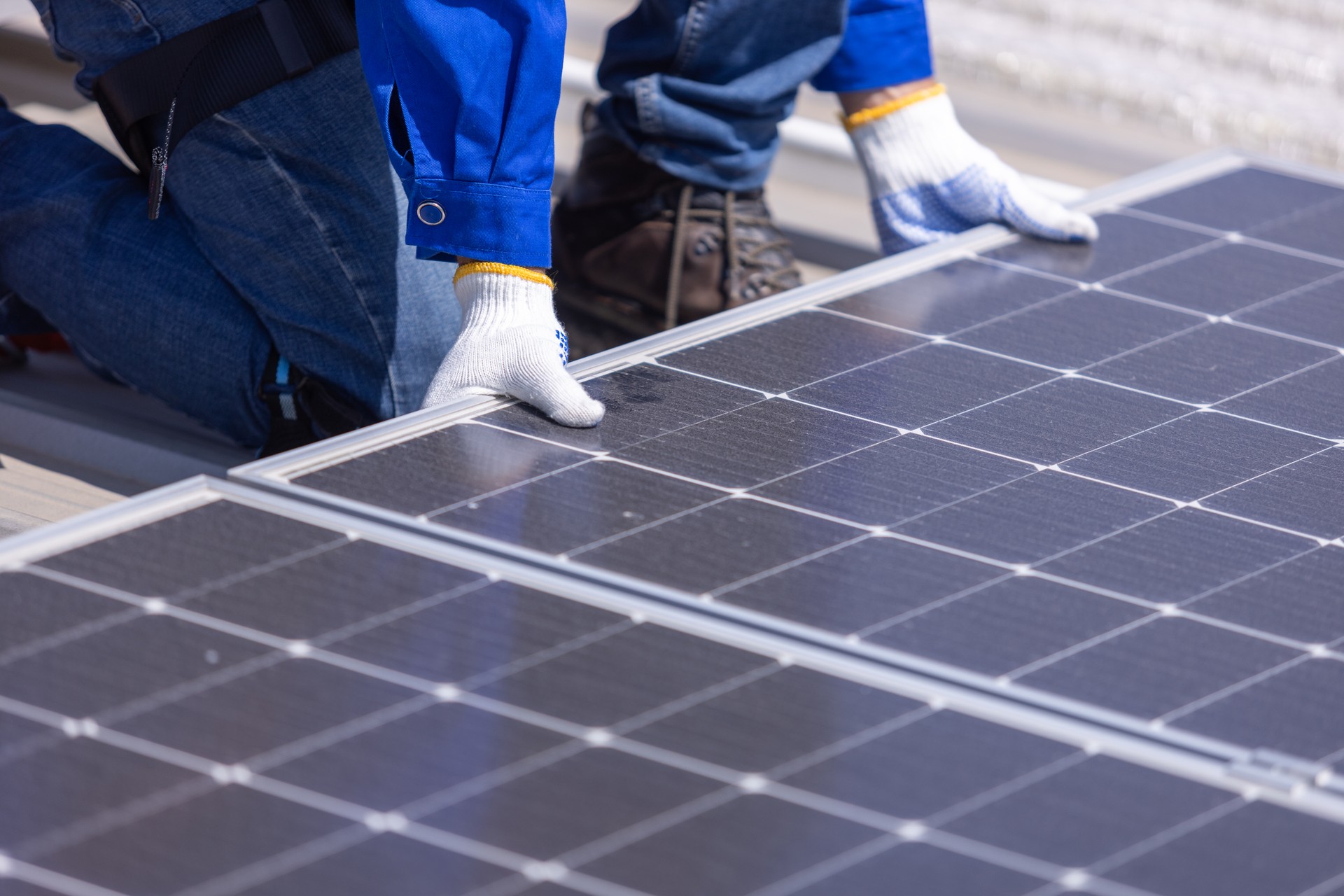 Technicians are installing and inspecting standards of solar panels on roof of an industrial factory. Electrical energy obtained from nature sunlight clean renewable energy.